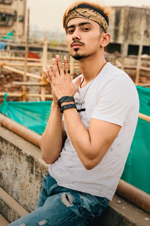 Adnaan Shaikh in white shirt and blue jeans at construction site