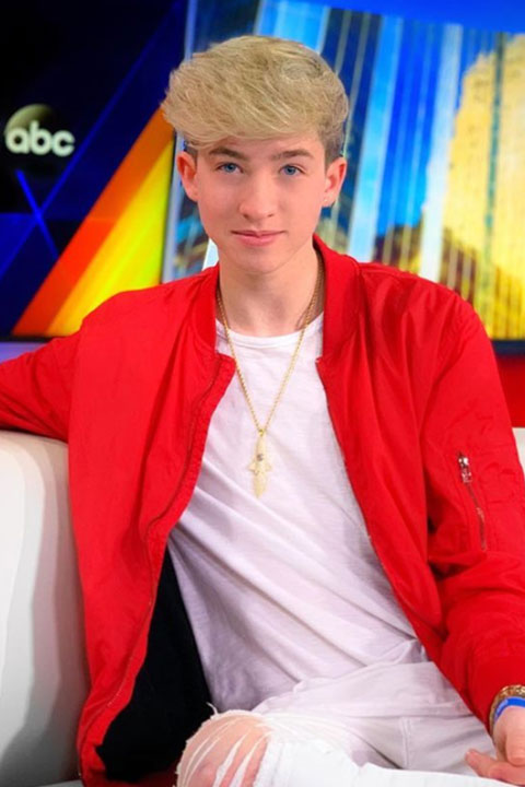 Cash Baker in white dress and red jacket