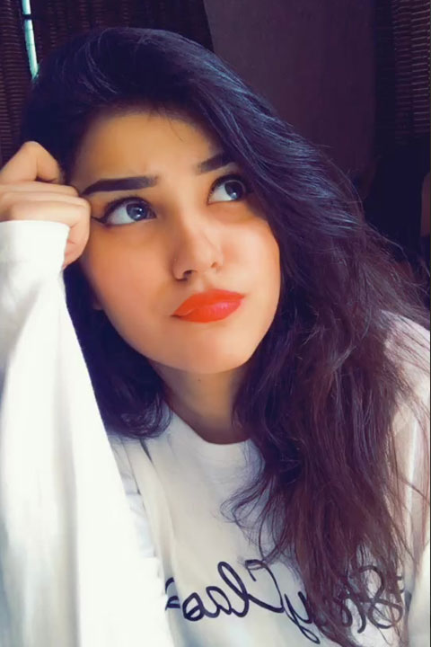 Hazeera being cute grumpy with her red lips and white shirt