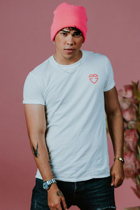 Jayden Croes wear a pink cap and white shirt and his wrist watch is looking beautiful.