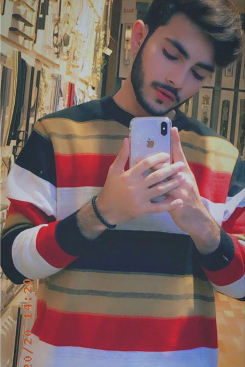 Mubeen Rehman wearing 3 color full sleeves shirt with white Iphone xmax in hand