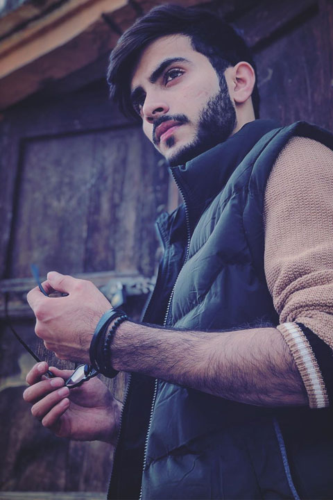 Mubeen Rehman Posing for picture, wearing half jacket and black bracelet