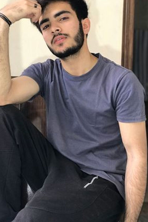 Mubeen Rehman Sitting and making pose for picture