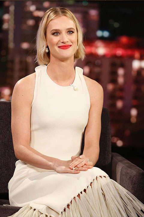 Mackenzie Davis in white sleeveless dress and red lipstick