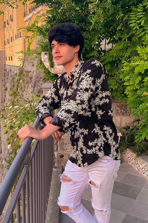 Alex Stokes looking handsome in his black shirt and white ripped jeans.