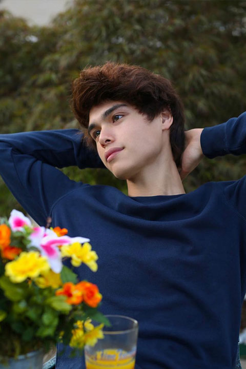 Alex Stokes relaxing. He is wearing dark blue shirt.