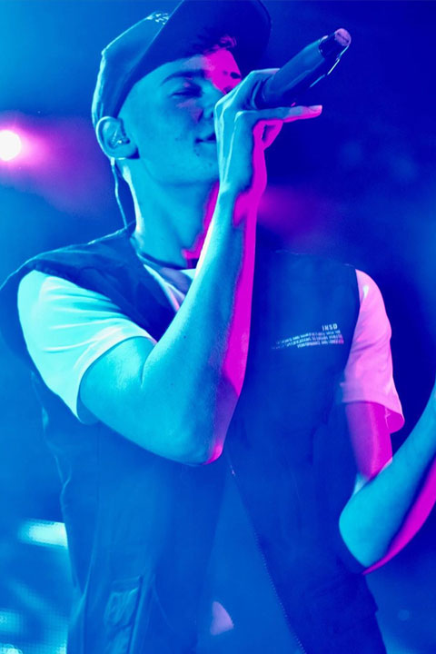 Max Mills at singing at concert.