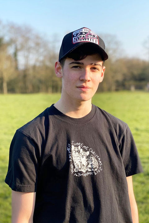 Max Mills at park. Wearing black t shirt