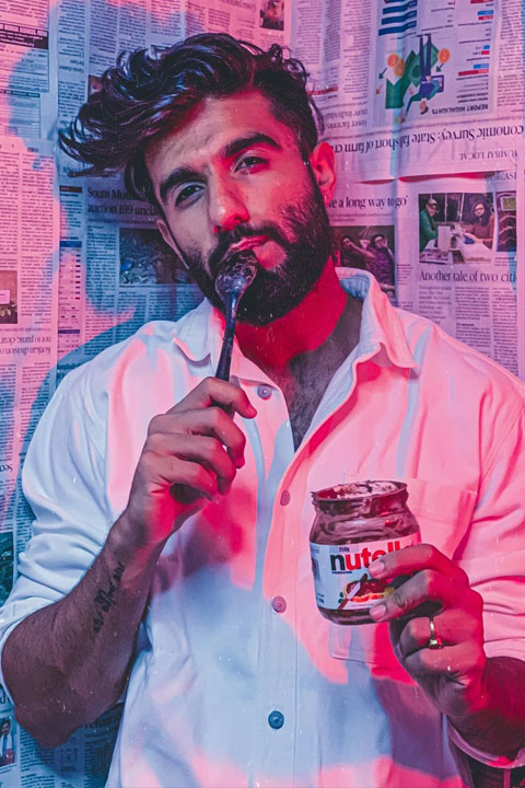 Manav Chhabra eating nutella seductively and wearing white shirt.