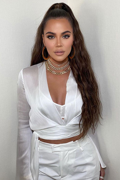 Khloe Kardashian is looking hot in white dress and ponytail.