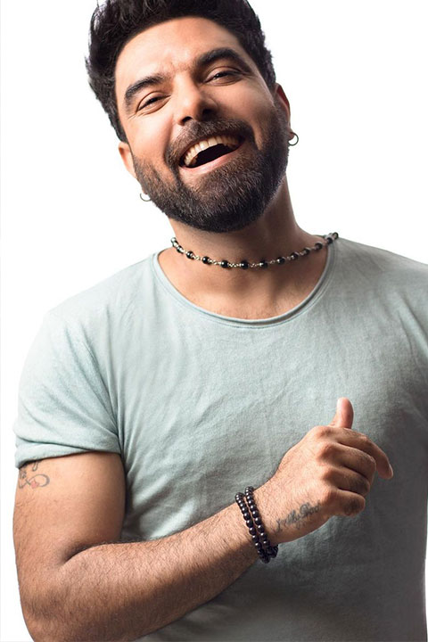 Yasir Hussain smiling in green tshirt