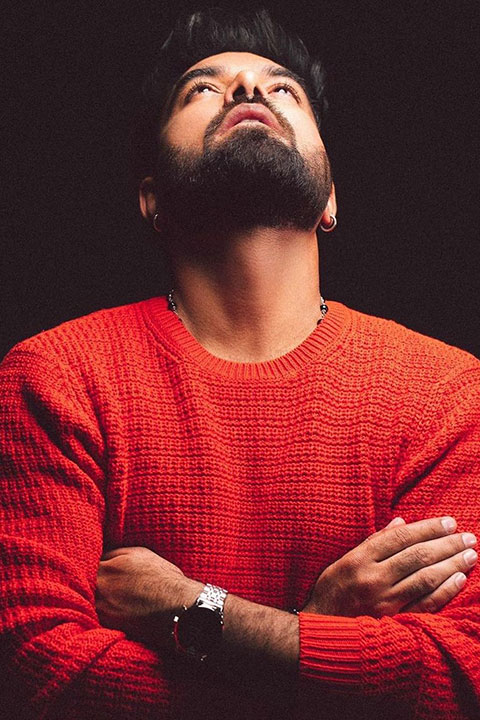 Yasir Hussain posing in red jersey