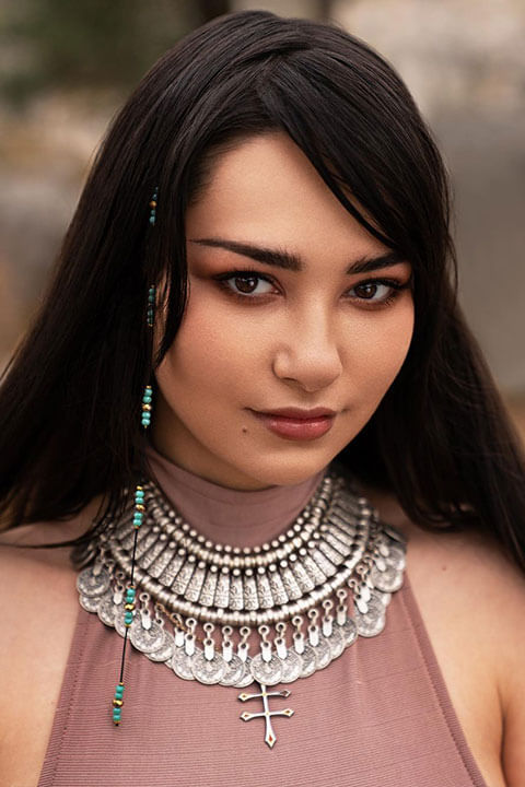 Helga Lovekaty Is wearing a beautiful necklace.