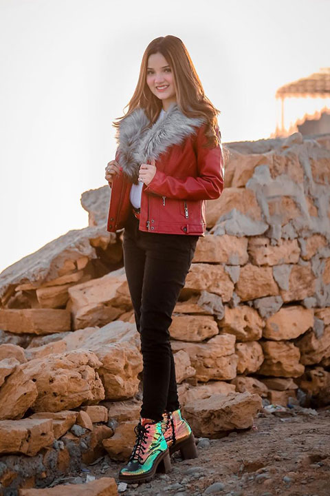 Rebecca khan in red jacket and black jeans