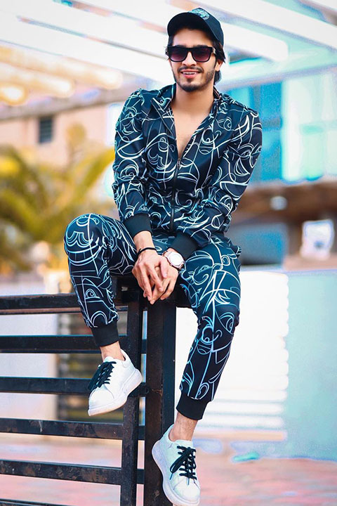 Faiz Baloch black track suite and white shoes