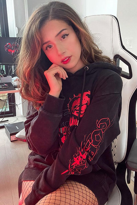 Imane Anys (Pokimane) is sit on a chair and she is posing for a picture.