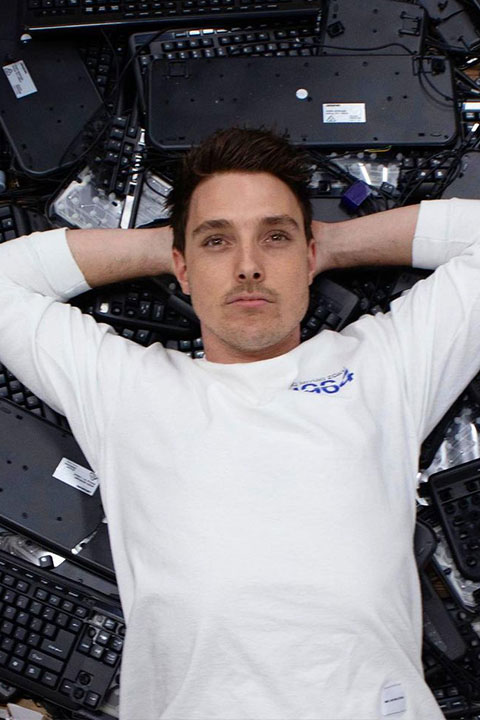 Lazar Beam in laying on keyboards in white tshirt