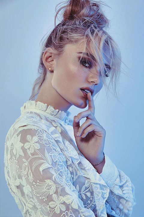 Meg Donnelly posing in white dress