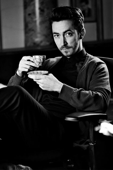 Michael Nicolae posing while taking cup of tea