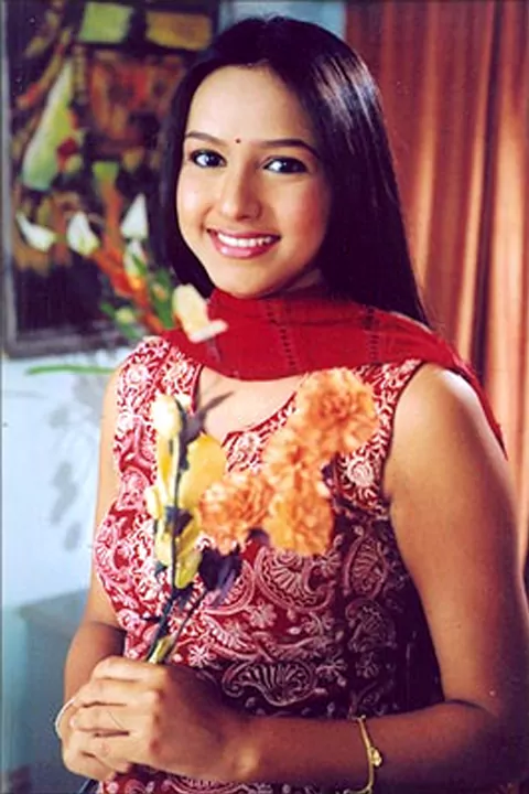 Gazala Selmin is smiling and posing for a picture.