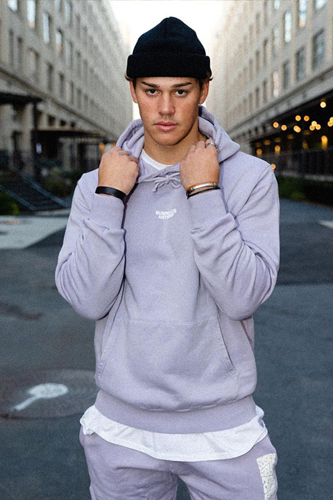 Noah Beck is looking beautiful in purple shirt and black cap.