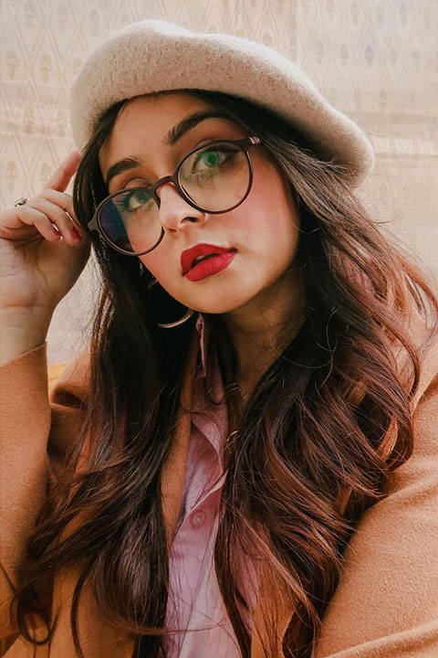 Vitasta Bhat is looking beautiful in brown coat and she wear a pink shirt and skin cap.