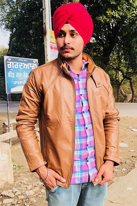 Jagjodh Bela is posing for picture in brown leather jacket