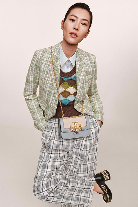 Liu Wen is looking at the camera and posing for a picture.
